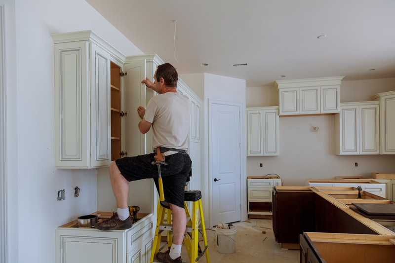 Man installing kitchen cabinet doors